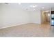 Large open floor plan with tile flooring, neutral walls, and a view into the kitchen at 669 E Victoria Trails Blvd, Deland, FL 32724