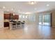 Open-concept living space boasts tile flooring, a modern kitchen island, and sliding glass doors to bring the outdoors in at 669 E Victoria Trails Blvd, Deland, FL 32724