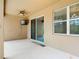 An outdoor patio including a ceiling fan and access to the pool area through sliding glass doors at 669 E Victoria Trails Blvd, Deland, FL 32724