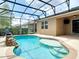 Sparkling in-ground pool with water feature in screened enclosure at 669 E Victoria Trails Blvd, Deland, FL 32724