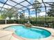 Relaxing screened-in pool with a peaceful Buddha statue fountain and comfortable patio seating at 669 E Victoria Trails Blvd, Deland, FL 32724
