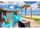 Inviting back deck with a seating area, fire pit, and a serene beach view beyond the palm trees at 787 Ocean Shore Blvd, Ormond Beach, FL 32176