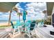 Spacious back deck overlooking a sandy beach and ocean, complete with comfortable seating and an umbrella at 787 Ocean Shore Blvd, Ormond Beach, FL 32176