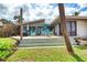 Beautiful backyard with a beach view, a large deck with colorful Adirondack chairs, and tropical landscaping at 787 Ocean Shore Blvd, Ormond Beach, FL 32176