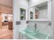 Stylish bathroom boasts a glass bowl sink, designer mirror and decorative greenery at 787 Ocean Shore Blvd, Ormond Beach, FL 32176