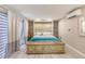 Bright bedroom showcases a decorative chest at the foot of the bed and stylish stone accent wall at 787 Ocean Shore Blvd, Ormond Beach, FL 32176