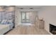 Bright bedroom features light wood floors, fireplace, and doors leading to the outside at 787 Ocean Shore Blvd, Ormond Beach, FL 32176
