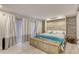 Bright bedroom showcases a decorative chest at the foot of the bed and stylish stone accent wall at 787 Ocean Shore Blvd, Ormond Beach, FL 32176