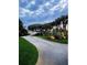 Beautiful, winding driveway with lush landscaping, mature trees, and serene views of the water at 787 Ocean Shore Blvd, Ormond Beach, FL 32176