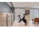 Exercise area featuring a stationary bike, large cabinet, and modern blinds at 787 Ocean Shore Blvd, Ormond Beach, FL 32176