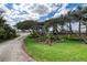 Beautifully landscaped front yard with winding driveway and lush greenery at 787 Ocean Shore Blvd, Ormond Beach, FL 32176