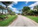 Well-maintained front yard with a long driveway leading up to a two-car garage at 787 Ocean Shore Blvd, Ormond Beach, FL 32176