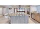 Large kitchen island features granite countertops, seating, and stainless steel appliances, perfect for entertaining at 787 Ocean Shore Blvd, Ormond Beach, FL 32176