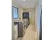 Bright laundry room features modern washer and dryer, utility sink, and ample storage space at 787 Ocean Shore Blvd, Ormond Beach, FL 32176