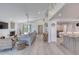Expansive living room connected to kitchen features an open floor plan, fireplace, and modern design elements at 787 Ocean Shore Blvd, Ormond Beach, FL 32176