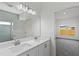 Bathroom featuring double vanity, a large mirror and a view to the bedroom at 810 W 24Th St, Sanford, FL 32771