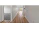 Hallway showcasing light wood flooring, white walls, and carpeted bedrooms at 810 W 24Th St, Sanford, FL 32771