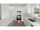Modern kitchen featuring white cabinets, stainless steel appliances, and a large island at 810 W 24Th St, Sanford, FL 32771