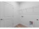 Functional laundry room with shelving, white walls, and laminate floors at 810 W 24Th St, Sanford, FL 32771