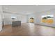 Open-concept living area featuring modern flooring, access to the kitchen, and a sliding glass door at 810 W 24Th St, Sanford, FL 32771