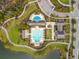 Aerial view of a neighborhood pool and clubhouse surrounded by a lake and lush landscaping at 8561 Randal Park Blvd, Orlando, FL 32832