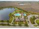 Aerial view of a neighborhood pool and clubhouse surrounded by a lake and lush landscaping at 8561 Randal Park Blvd, Orlando, FL 32832