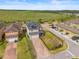 Aerial view of a well maintained home exterior featuring a black fenced-in yard and a playground in a neighborhood at 8561 Randal Park Blvd, Orlando, FL 32832