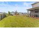 Enjoy the spacious backyard with a swing set, green grass, and black metal fence at 8561 Randal Park Blvd, Orlando, FL 32832