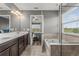 Bathroom featuring a soaking tub and double sink vanity at 8561 Randal Park Blvd, Orlando, FL 32832