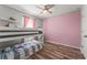 Cozy bedroom featuring a bunk bed, wood floors, and soft, cheerful colors at 8561 Randal Park Blvd, Orlando, FL 32832