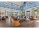 Clubhouse interior with stylish seating, wooden floors, light blue walls, and views of the lake at 8561 Randal Park Blvd, Orlando, FL 32832