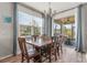 Bright dining room featuring a wooden table, chairs, large window, and access to a screened-in patio at 8561 Randal Park Blvd, Orlando, FL 32832