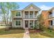 Charming two-story home with a quaint front porch and a beautifully landscaped yard at 8561 Randal Park Blvd, Orlando, FL 32832