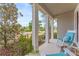 Inviting front porch featuring rocking chairs with cushions and a peaceful view of the neighborhood at 8561 Randal Park Blvd, Orlando, FL 32832