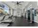 Bright gym featuring modern exercise equipment, a ceiling fan, multiple windows, and an exit door at 8561 Randal Park Blvd, Orlando, FL 32832