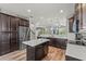 Well-equipped kitchen with stainless steel appliances, quartz countertops, an island, and hardwood floors at 8561 Randal Park Blvd, Orlando, FL 32832