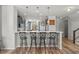 Modern kitchen featuring a breakfast bar with seating, pendant lighting, stainless steel appliances, and open layout at 8561 Randal Park Blvd, Orlando, FL 32832