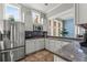 Modern kitchenette featuring granite countertops, stainless steel appliances, and ample cabinet space at 8561 Randal Park Blvd, Orlando, FL 32832