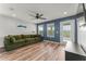Bright living room features wood floors, ceiling fan, and sliding glass doors to the balcony at 8561 Randal Park Blvd, Orlando, FL 32832