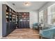 Cozy living room with hardwood floors, built-in bookcases, comfortable seating, and natural light from the windows at 8561 Randal Park Blvd, Orlando, FL 32832