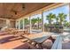 Charming outdoor picnic area featuring wooden tables, a ceiling fan, and a beautiful view of palm trees at 8561 Randal Park Blvd, Orlando, FL 32832