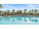 Stunning community pool with lounge chairs and palm trees is a perfect place to relax and enjoy the Florida sunshine at 8561 Randal Park Blvd, Orlando, FL 32832