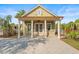 Charming pool house with a cozy covered porch, white pillars, and an inviting entrance is perfect for relaxing at 8561 Randal Park Blvd, Orlando, FL 32832