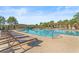 Inviting community pool with lounge chairs and shade, perfect for enjoying the Florida weather at 8561 Randal Park Blvd, Orlando, FL 32832