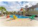Entertaining splash pad area featuring colorful play equipment and lounge chairs, perfect for a sunny day of play at 8561 Randal Park Blvd, Orlando, FL 32832