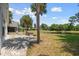 Enjoy the outdoors on the paver patio with a water view in the backyard with palm trees at 914 Smokerise Blvd, Port Orange, FL 32127