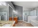 Bathroom with a glass shower, granite counters, double sinks and modern fixtures at 914 Smokerise Blvd, Port Orange, FL 32127