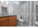 Well-lit bathroom featuring double sinks, granite counters, framed mirror, and shower with decorative curtain at 914 Smokerise Blvd, Port Orange, FL 32127