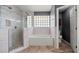 Bathroom featuring a glass shower, white subway tiles and a soaking tub at 914 Smokerise Blvd, Port Orange, FL 32127