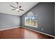 Bedroom with hardwood floors, ceiling fan and a view of the neighborhood at 914 Smokerise Blvd, Port Orange, FL 32127